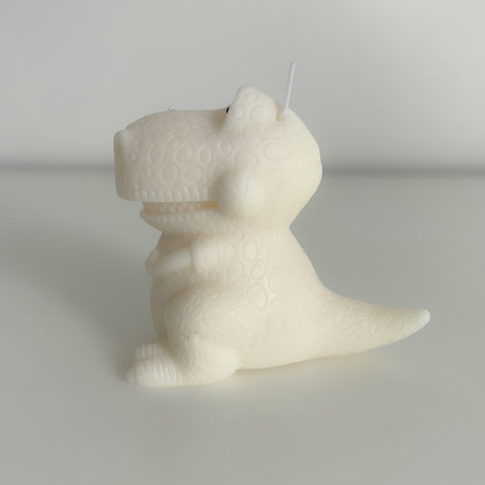 Photo d'une bougie dinosaure blanche, de profil