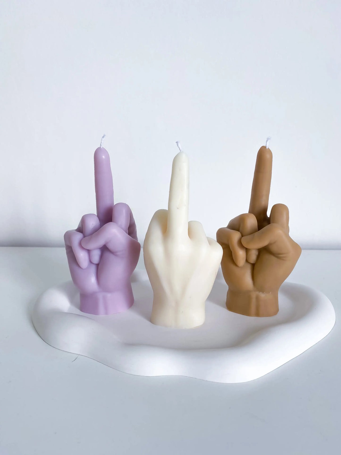 3 bougies fuck you, l'une violette, la seconde blanche et la troisième marron