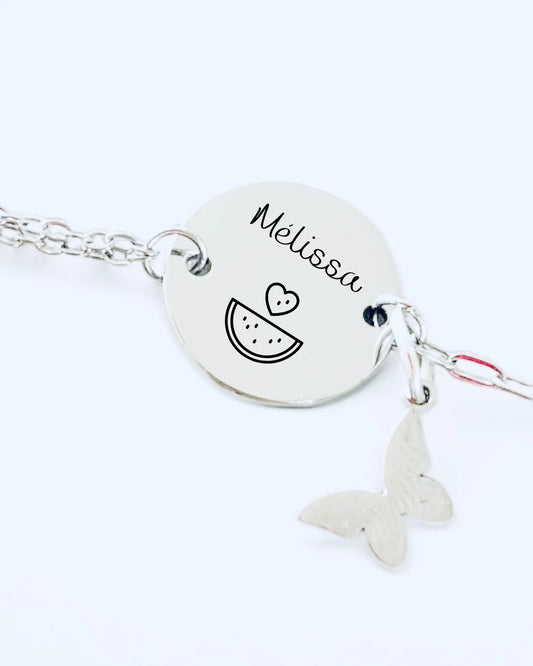 Photo d'un bracelet avec médaille à graver et charm papillon